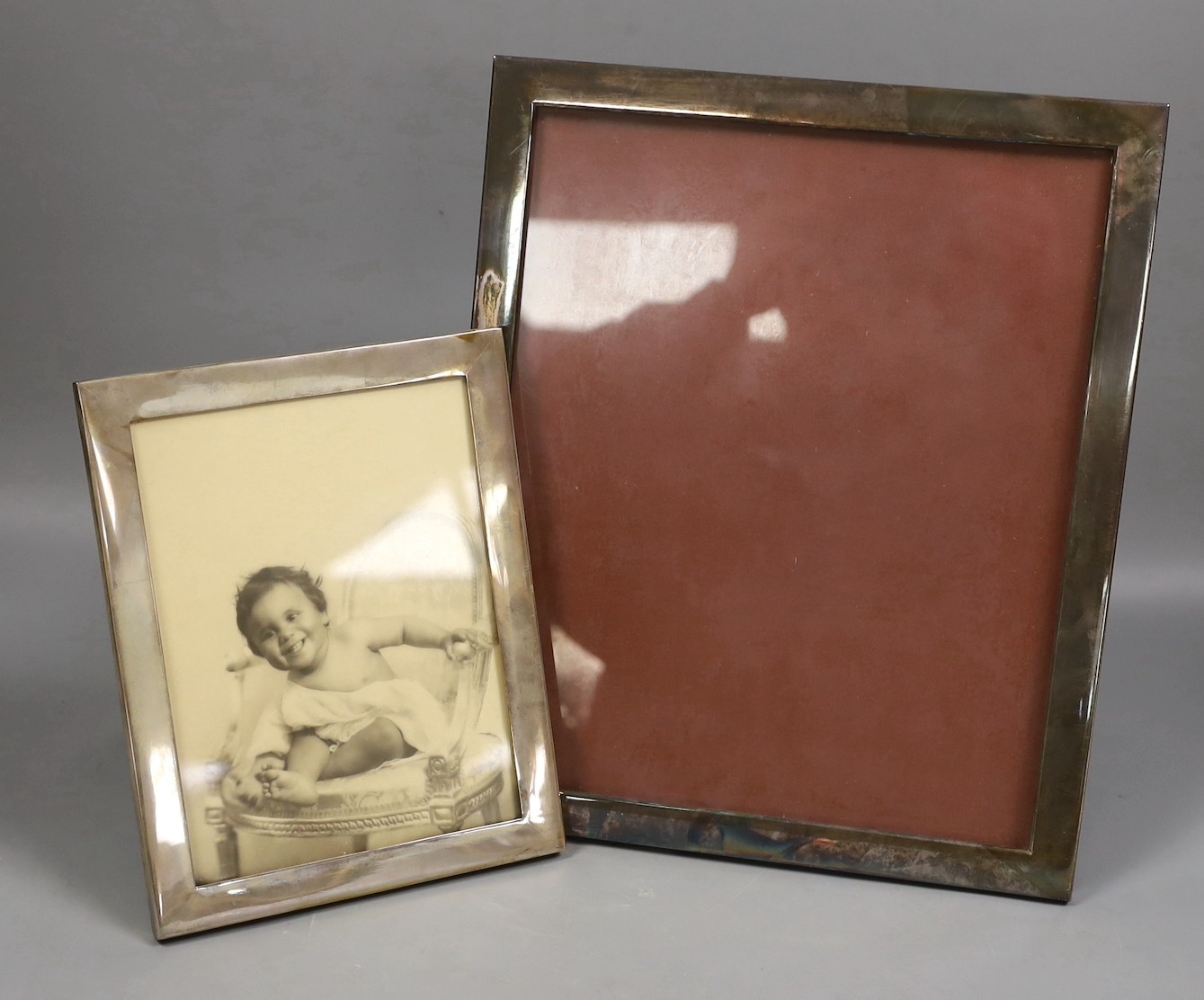 A large German 835 standard white metal mounted rectangular photograph frame, 34cm and a smaller Greek 900 standard mounted frame, 23.4cm.